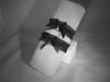 Black ruffle strap with bow and rhinestone charm